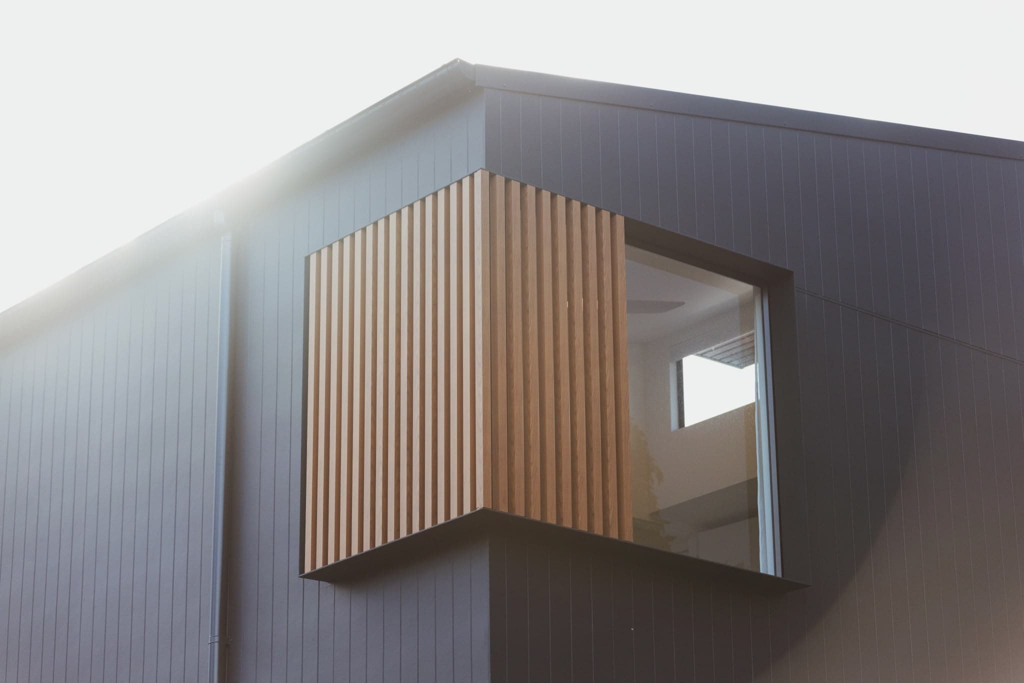 Architectural corner window and cantilevered timber-batten screen detail, the result of close builder-architect collaboration