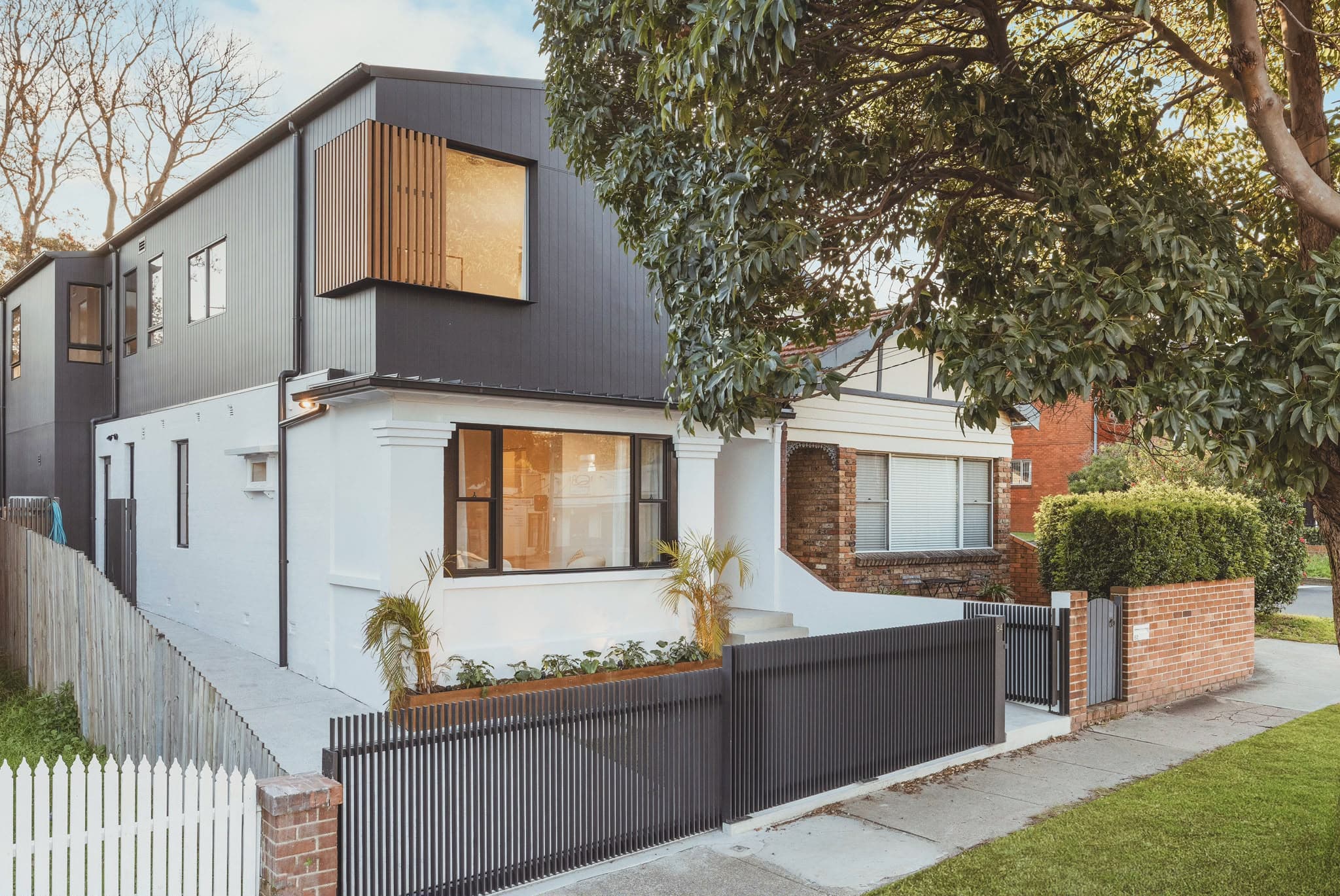 Renovated federation cottage with charcoal-clad second storey addition, Sydney